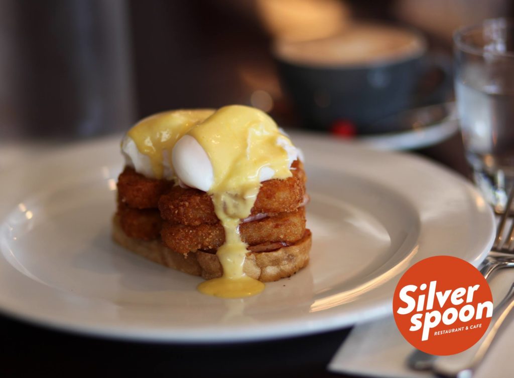 Hash Stack: layers of hash browns and bacon, topped with poached eggs and hollandaise sauce.